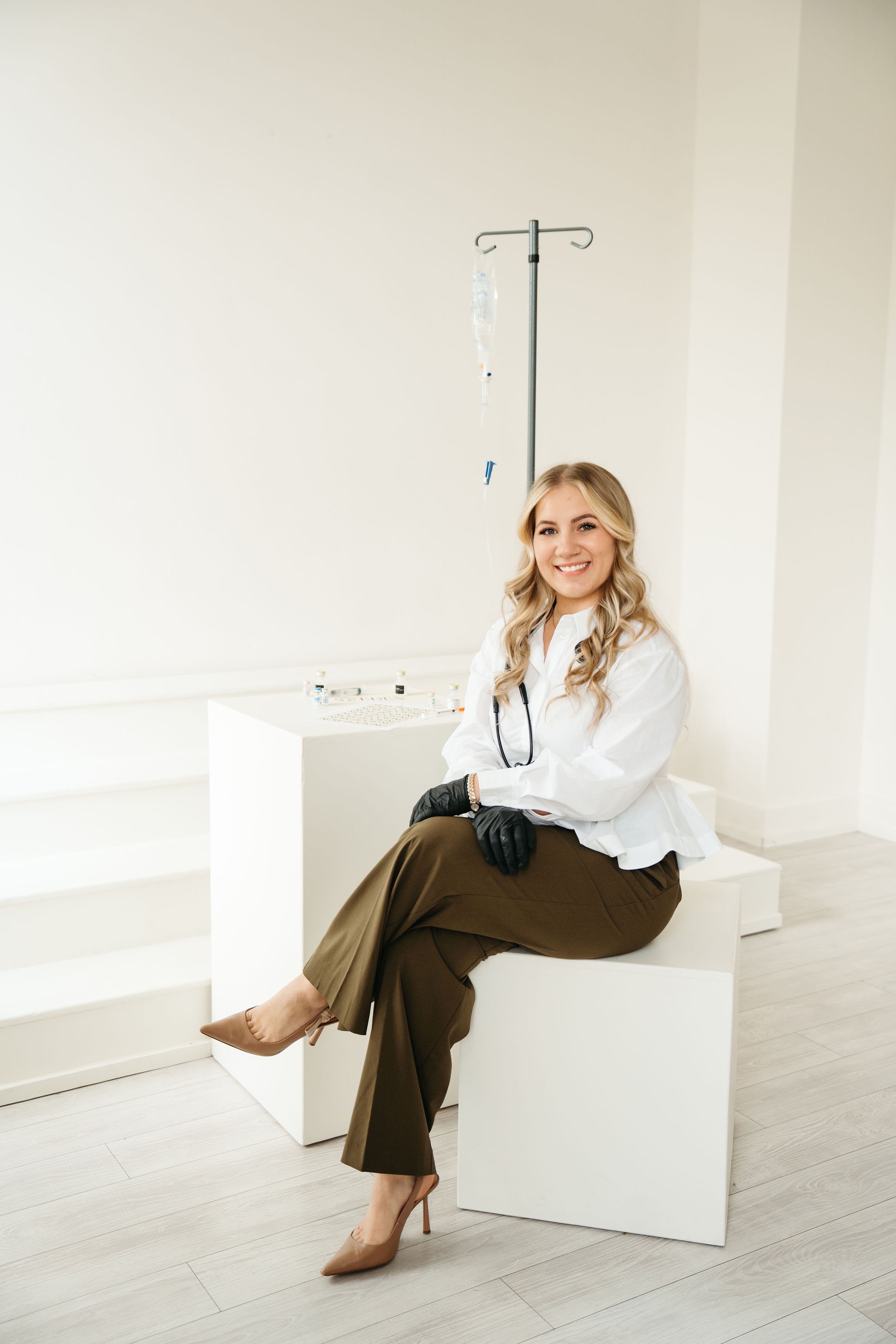 Olga Kosovan, RN, seated beside an IV stand